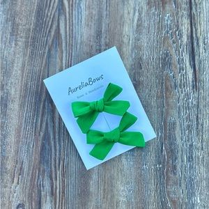 Homemade pigtail tied bow in green.